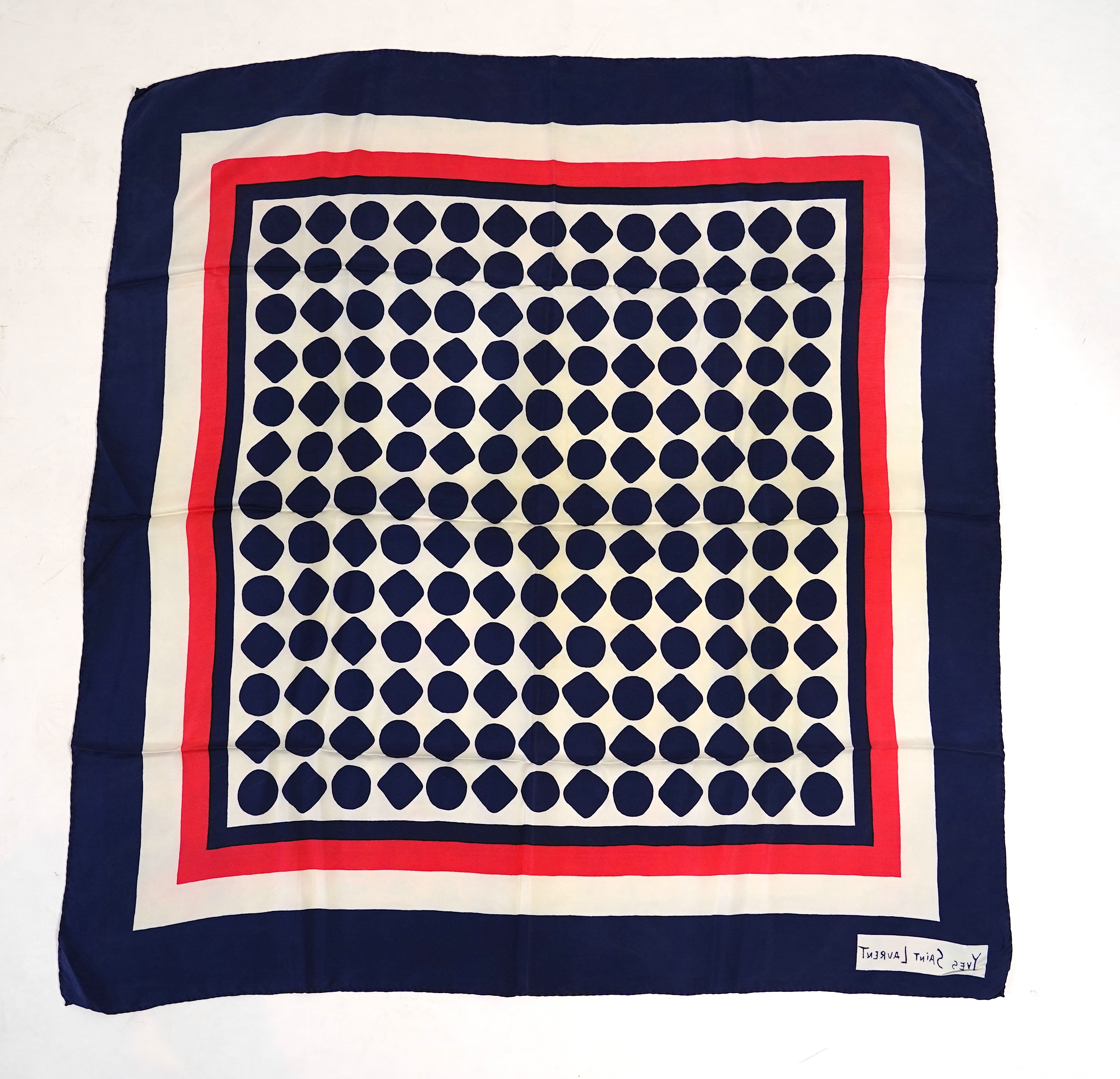 A Yves Saint Laurent silk scarf, a Jean Cocteau zodiac design silk scarf and a Rodier silk scarf.